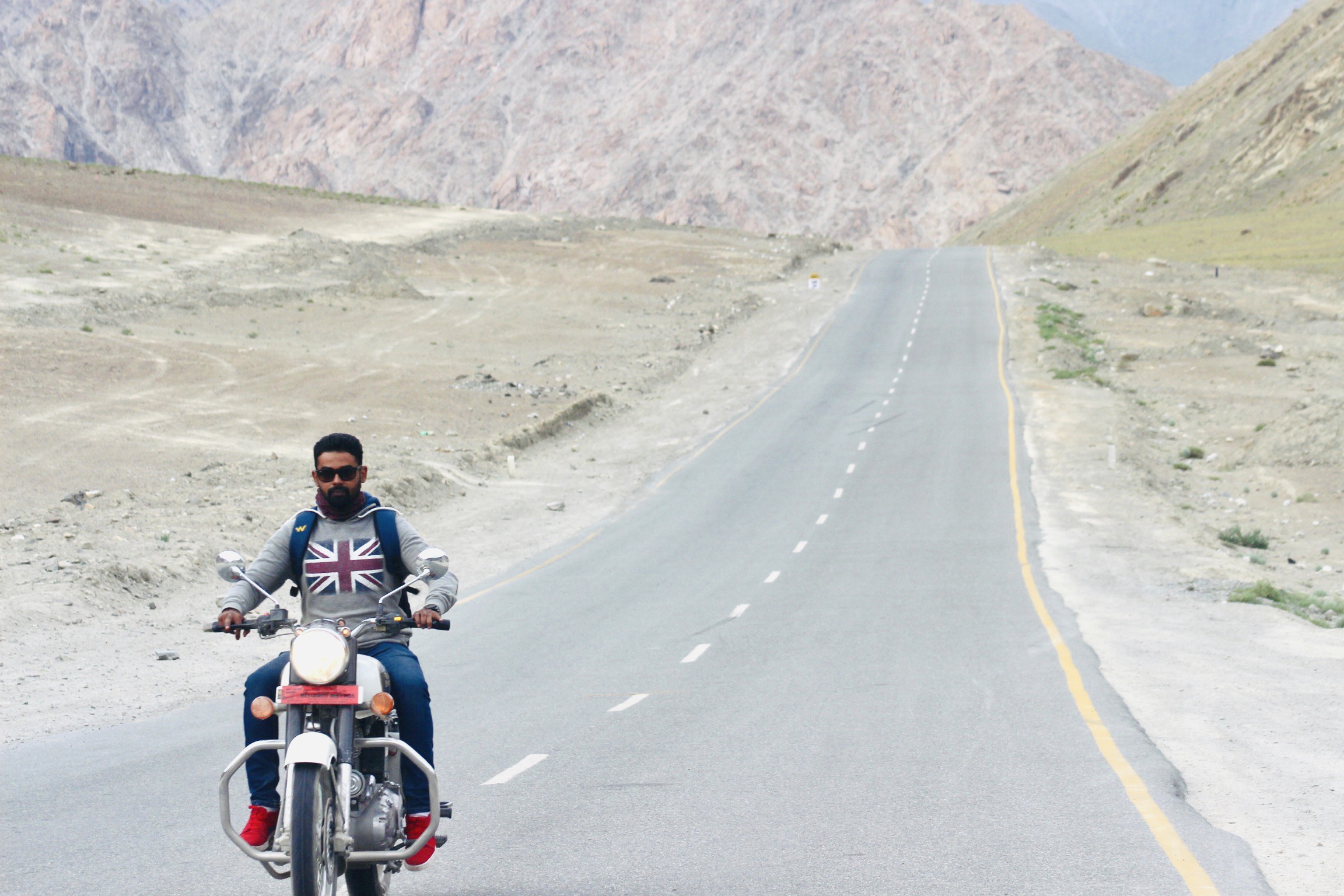 RK riding a bike through the mountains in Ladakh